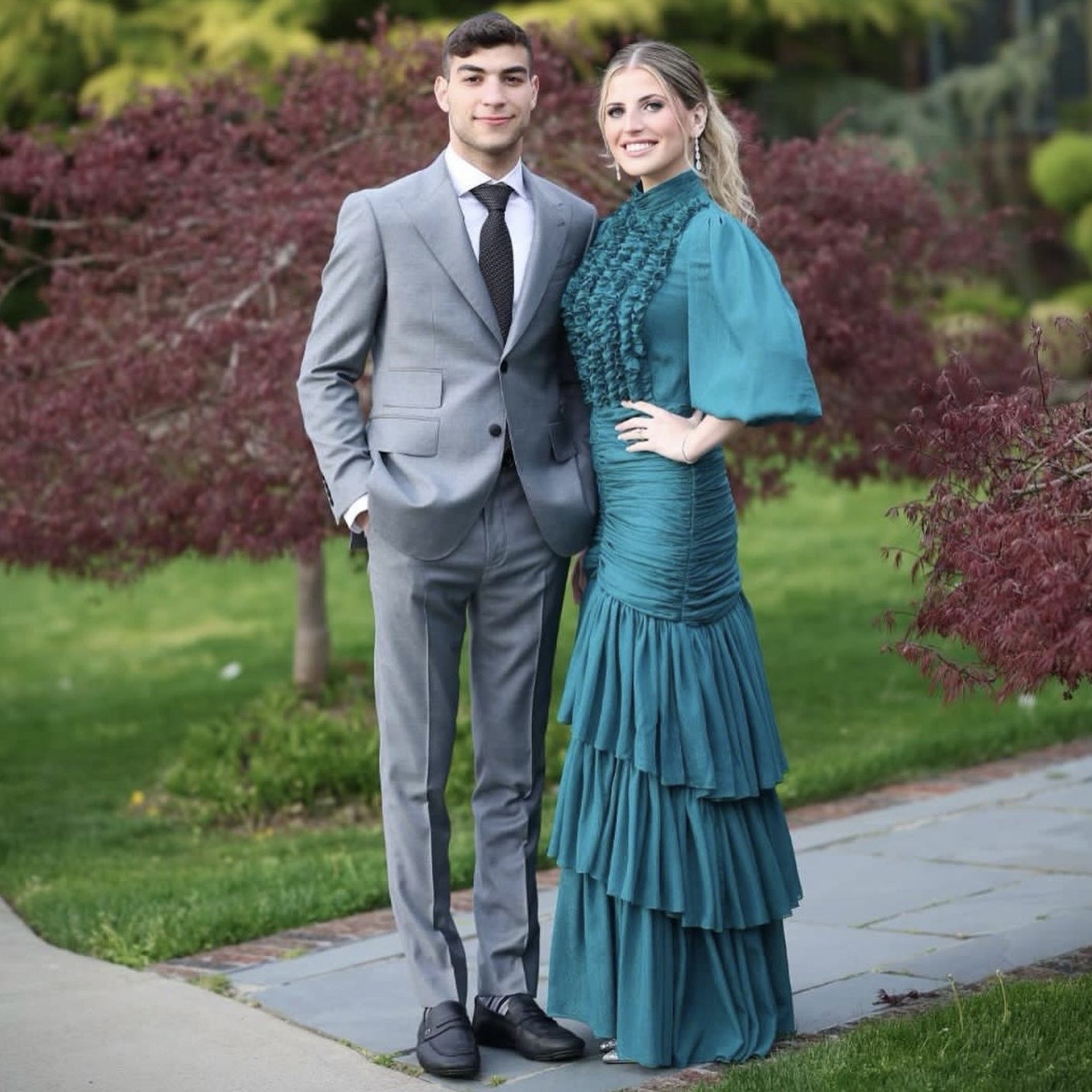 Client wearing a custom gray suit at an outdoor event